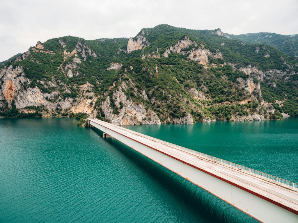 Bridge over Lake Piva with mountains in the background. Montenegro